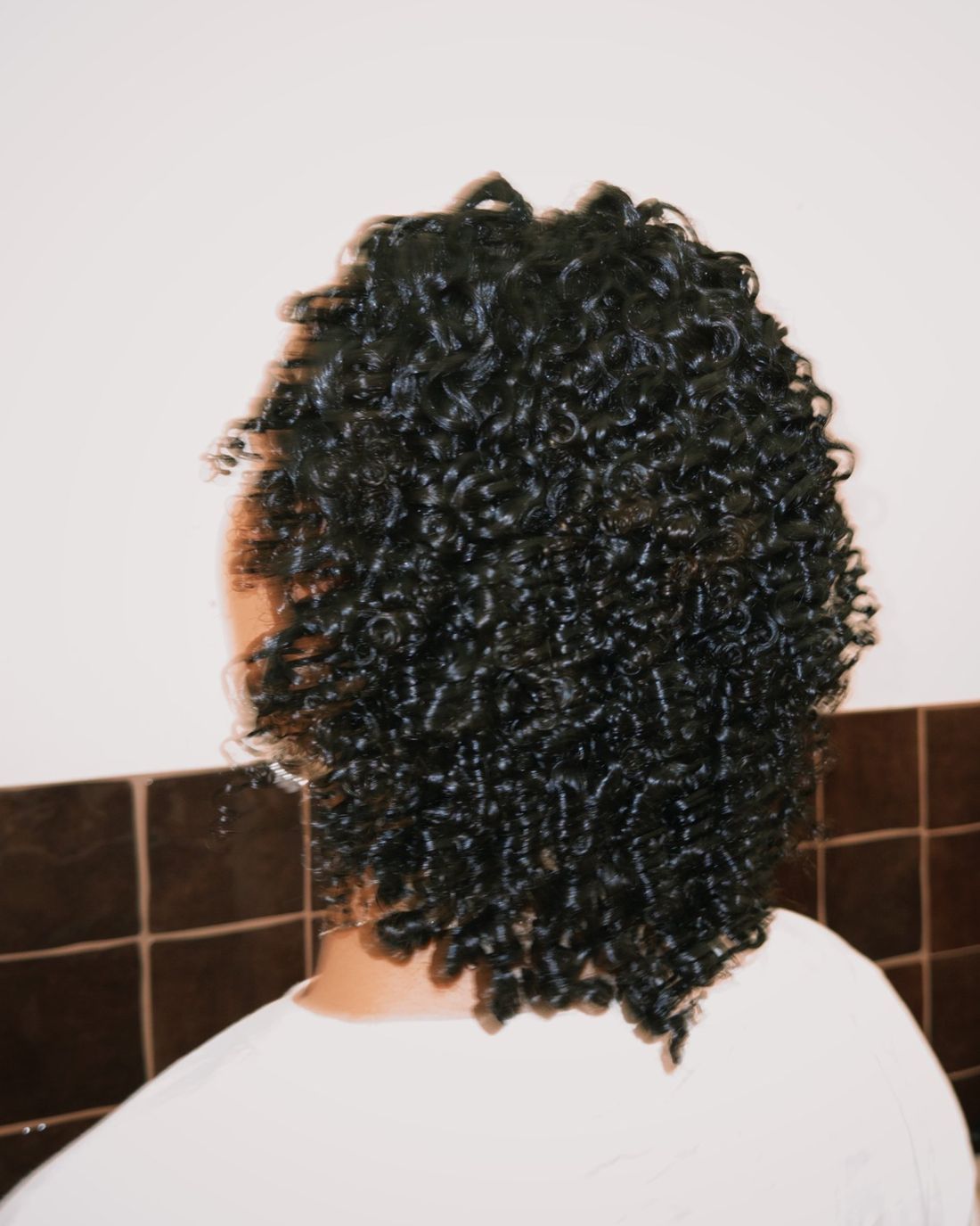 The back of a client's freshly defined curls