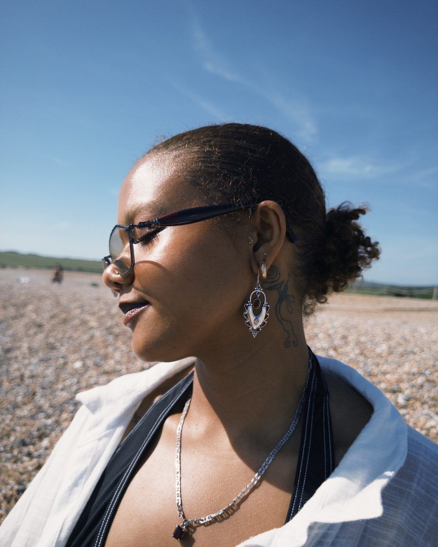 Nera, smiling in the sun on a pebble beach